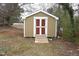 Exterior view of a backyard shed with a charming ramp and double-door entrance at 464 Longfellow St, Fuquay Varina, NC 27526