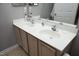 Bathroom featuring a double vanity with light cabinets, a large mirror, and light countertops at 4905 Briarstone Ct, Raleigh, NC 27610