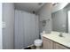 Neutral bathroom featuring a shower with curtain, white toilet and vanity with cream countertop at 4905 Briarstone Ct, Raleigh, NC 27610