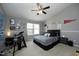 Cozy bedroom features neutral walls, ceiling fan, a large window, and personal decor at 4905 Briarstone Ct, Raleigh, NC 27610