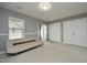 Spacious bedroom with neutral carpet and paint, a futon, dual closets and a sliding glass door at 4905 Briarstone Ct, Raleigh, NC 27610