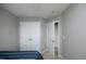 Bedroom with a blue bedspread, a closet with double doors, and neutral walls at 4905 Briarstone Ct, Raleigh, NC 27610