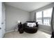 Cozy bedroom space with a comfortable round chair, ample natural light, and neutral tones at 4905 Briarstone Ct, Raleigh, NC 27610