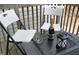 Close-up view of a decorated outdoor deck, featuring a bottle of wine, glasses, and a lantern at 4905 Briarstone Ct, Raleigh, NC 27610