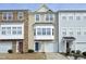 Charming townhome featuring varied textures: stone, vinyl siding, and inviting curb appeal with small shrubbery at 4905 Briarstone Ct, Raleigh, NC 27610