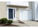Well-maintained townhome with a clean garage, tidy landscaping, and a welcoming blue front door at 4905 Briarstone Ct, Raleigh, NC 27610