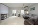 Bright living room with sliding door access to deck, neutral tones, ceiling fan, and comfortable furniture at 4905 Briarstone Ct, Raleigh, NC 27610