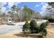 View of the community parking lot with mature trees and landscaping on a sunny day with a partially cloudy sky at 4905 Briarstone Ct, Raleigh, NC 27610