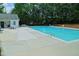 Community pool with lounge chairs surrounded by trees at 4905 Briarstone Ct, Raleigh, NC 27610