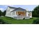 Beautiful home with a covered porch, ample windows, and a lush green lawn at 525 Peebles St, Raleigh, NC 27608