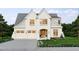 Charming two-story home with white painted brick, an attached three-car garage, and beautifully landscaped yard at 525 Peebles St, Raleigh, NC 27608