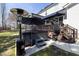 Outdoor patio featuring a luxurious hot tub, patio heaters, and stylish umbrella for year-round enjoyment at 5600 Abbey Grace Ln, Wake Forest, NC 27587