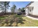 Spacious backyard with a hot tub, mature trees, and a well-manicured lawn, providing privacy and tranquility at 5600 Abbey Grace Ln, Wake Forest, NC 27587