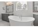 Bright bathroom featuring a standalone tub, a vanity, and neutral-toned walls at 5600 Abbey Grace Ln, Wake Forest, NC 27587