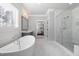 Bright bathroom featuring a standalone tub, and a marble-walled shower at 5600 Abbey Grace Ln, Wake Forest, NC 27587