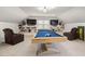 Large bonus room featuring a pool table, built-in shelving, seating, and natural light at 5600 Abbey Grace Ln, Wake Forest, NC 27587