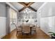 Cozy dining room featuring a round table, wood beam ceilings, and ample natural light from a large window at 5600 Abbey Grace Ln, Wake Forest, NC 27587