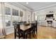 Bright dining area featuring hardwood floors, large windows, and seamless connection to the living room at 5600 Abbey Grace Ln, Wake Forest, NC 27587