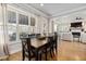 A formal dining room features a wooden table with seating for six and a large window at 5600 Abbey Grace Ln, Wake Forest, NC 27587