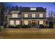 Attractive home with a well-lit front exterior at dusk, highlighting the inviting entrance and landscaped yard at 5600 Abbey Grace Ln, Wake Forest, NC 27587