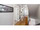 Hallway featuring built-in bookshelves, decorative sign, and hardwood floors at 5600 Abbey Grace Ln, Wake Forest, NC 27587