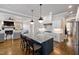 This kitchen features a large island with counter seating, perfect for entertaining and hardwood floors at 5600 Abbey Grace Ln, Wake Forest, NC 27587