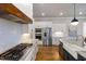 This kitchen features white cabinets, stainless steel appliances, granite counters and gas stovetop at 5600 Abbey Grace Ln, Wake Forest, NC 27587