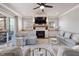 This living room features light gray furniture, fireplace with a TV, built-in cabinets and hardwood flooring at 5600 Abbey Grace Ln, Wake Forest, NC 27587