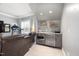 Living room bar and beverage area with a TV, treadmill, and leather seating at 5600 Abbey Grace Ln, Wake Forest, NC 27587