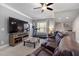 Living room with a large screen TV, treadmill, leather seating, and mini bar at 5600 Abbey Grace Ln, Wake Forest, NC 27587