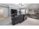 Spacious living room featuring a bar, leather seating, and large screen television at 5600 Abbey Grace Ln, Wake Forest, NC 27587