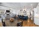 An open-concept living space with a dining area, kitchen island with seating and hardwood floors at 5600 Abbey Grace Ln, Wake Forest, NC 27587