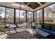 Relaxing screened porch with comfortable seating, hammock, and stylish decor perfect for enjoying the outdoors at 5600 Abbey Grace Ln, Wake Forest, NC 27587
