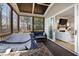Cozy screened porch featuring a hammock, comfortable seating, and seamless transition to the living room at 5600 Abbey Grace Ln, Wake Forest, NC 27587