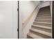 Carpeted staircase with a wooden handrail leading to the upper level of the home at 5600 Abbey Grace Ln, Wake Forest, NC 27587