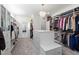 Well-organized walk-in closet with ample storage, custom shelves, drawers, a bench and soft carpeting at 5600 Abbey Grace Ln, Wake Forest, NC 27587