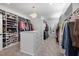 Spacious walk-in closet features custom shelving, drawers, carpeted floors and a stylish chandelier at 5600 Abbey Grace Ln, Wake Forest, NC 27587