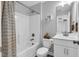 Bright bathroom with a shower-tub combo and a modern sink and vanity with decorative fixtures at 59 N Clearbrook Ct, Angier, NC 27501