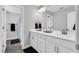 Bright bathroom featuring a double sink vanity with white cabinets and modern fixtures at 59 N Clearbrook Ct, Angier, NC 27501