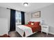 Cozy bedroom featuring a white bed frame, dark curtains, and a charming 'Rise' wall decor at 59 N Clearbrook Ct, Angier, NC 27501