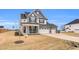 Beautiful two-story home featuring stone accents, a three-car garage, and a welcoming front porch at 59 N Clearbrook Ct, Angier, NC 27501