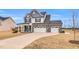 Charming two-story home boasting a three-car garage and covered front porch with rocking chairs at 59 N Clearbrook Ct, Angier, NC 27501