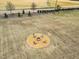 Aerial shot featuring a backyard fire pit with chairs in an expansive grassy area at 59 N Clearbrook Ct, Angier, NC 27501
