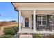 Inviting covered front porch with rocking chairs and a decorative wreath on the navy front door at 59 N Clearbrook Ct, Angier, NC 27501