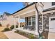 Charming covered front porch with rocking chairs offering a cozy and welcoming curb appeal at 59 N Clearbrook Ct, Angier, NC 27501