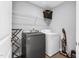Functional laundry room with a washer, dryer, shelving, and ample space for sorting and folding at 59 N Clearbrook Ct, Angier, NC 27501