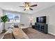 Relaxing living room featuring neutral colors, a ceiling fan, and large window that brings in natural light at 59 N Clearbrook Ct, Angier, NC 27501