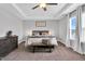 Inviting main bedroom with a tray ceiling, ceiling fan, and large windows offering ample natural light at 59 N Clearbrook Ct, Angier, NC 27501