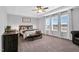 Inviting main bedroom with a tray ceiling, ceiling fan, and large windows offering ample natural light at 59 N Clearbrook Ct, Angier, NC 27501
