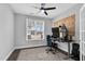 Bright home office with large window, gaming setup, ceiling fan, and stylish area rug at 59 N Clearbrook Ct, Angier, NC 27501